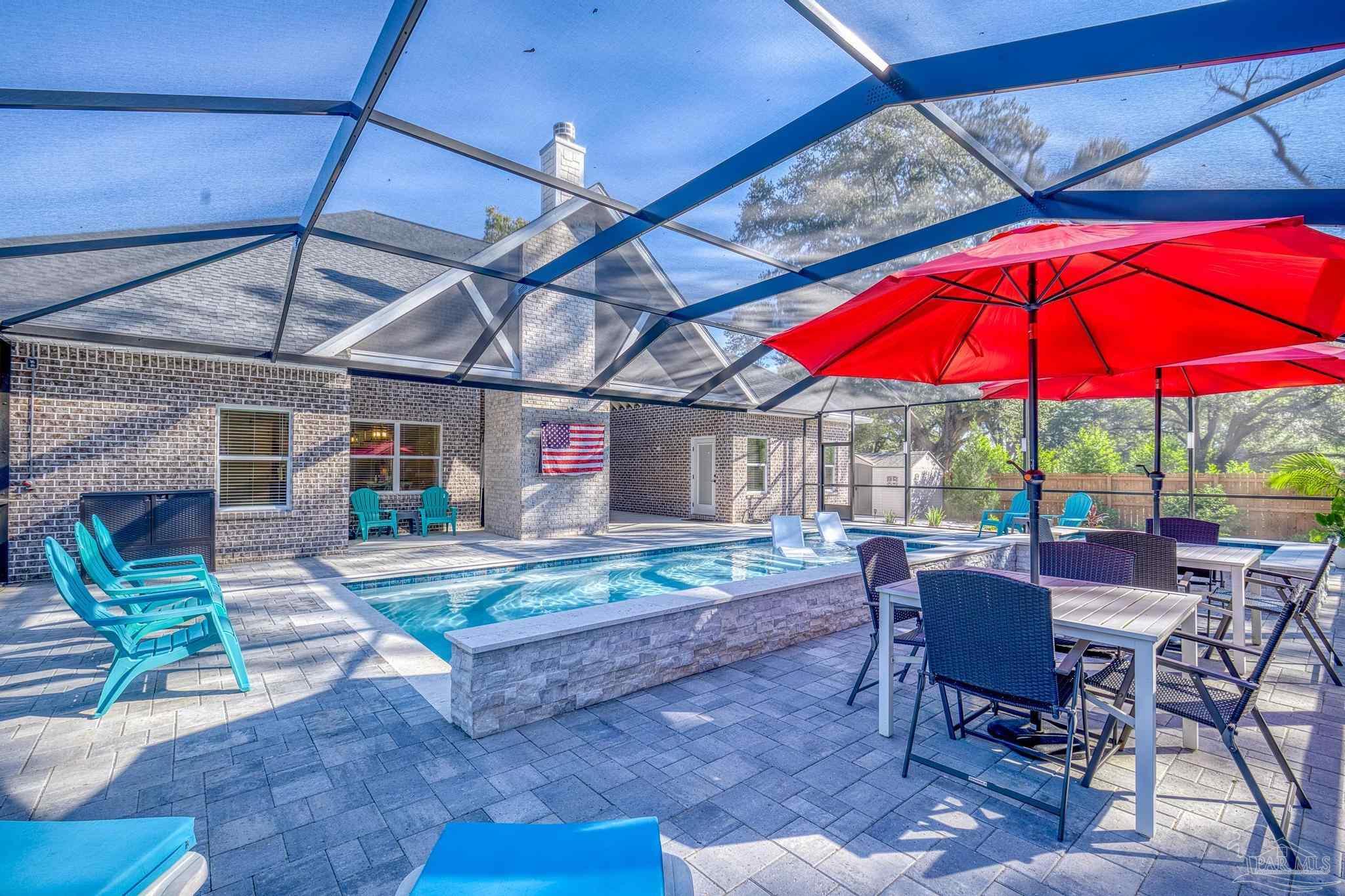 8415 Beulah Road Pensacola, FL 32526 - Photo 42 of 59 a patio with a table and chairs