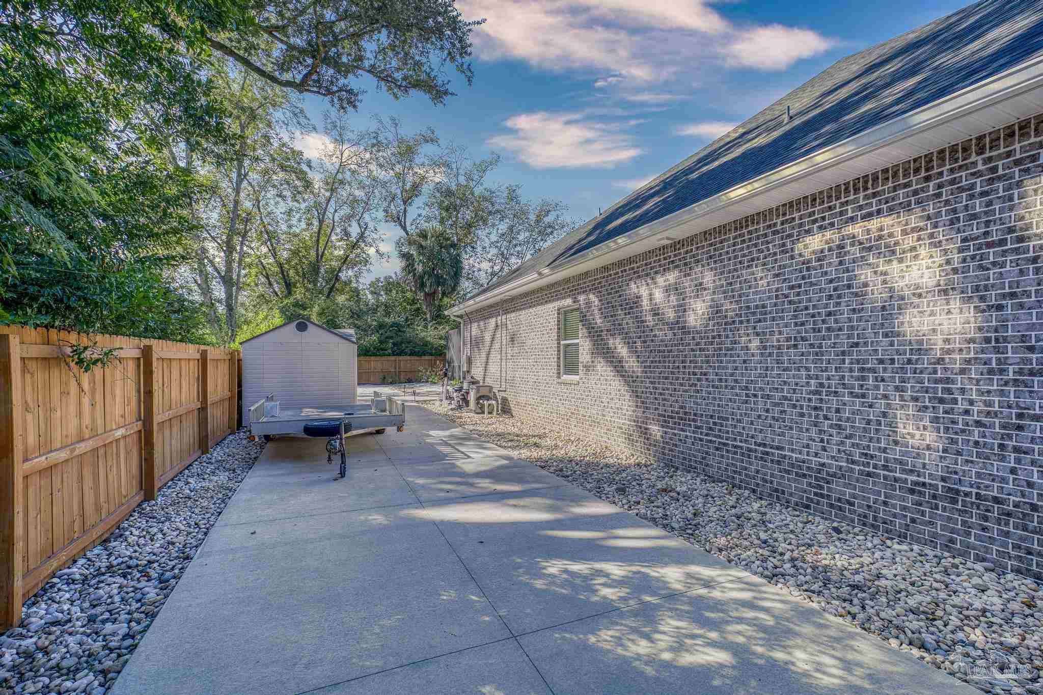 8415 Beulah Road Pensacola, FL 32526 - Photo 52 of 59 a backyard of a house with chairs and wooden fence