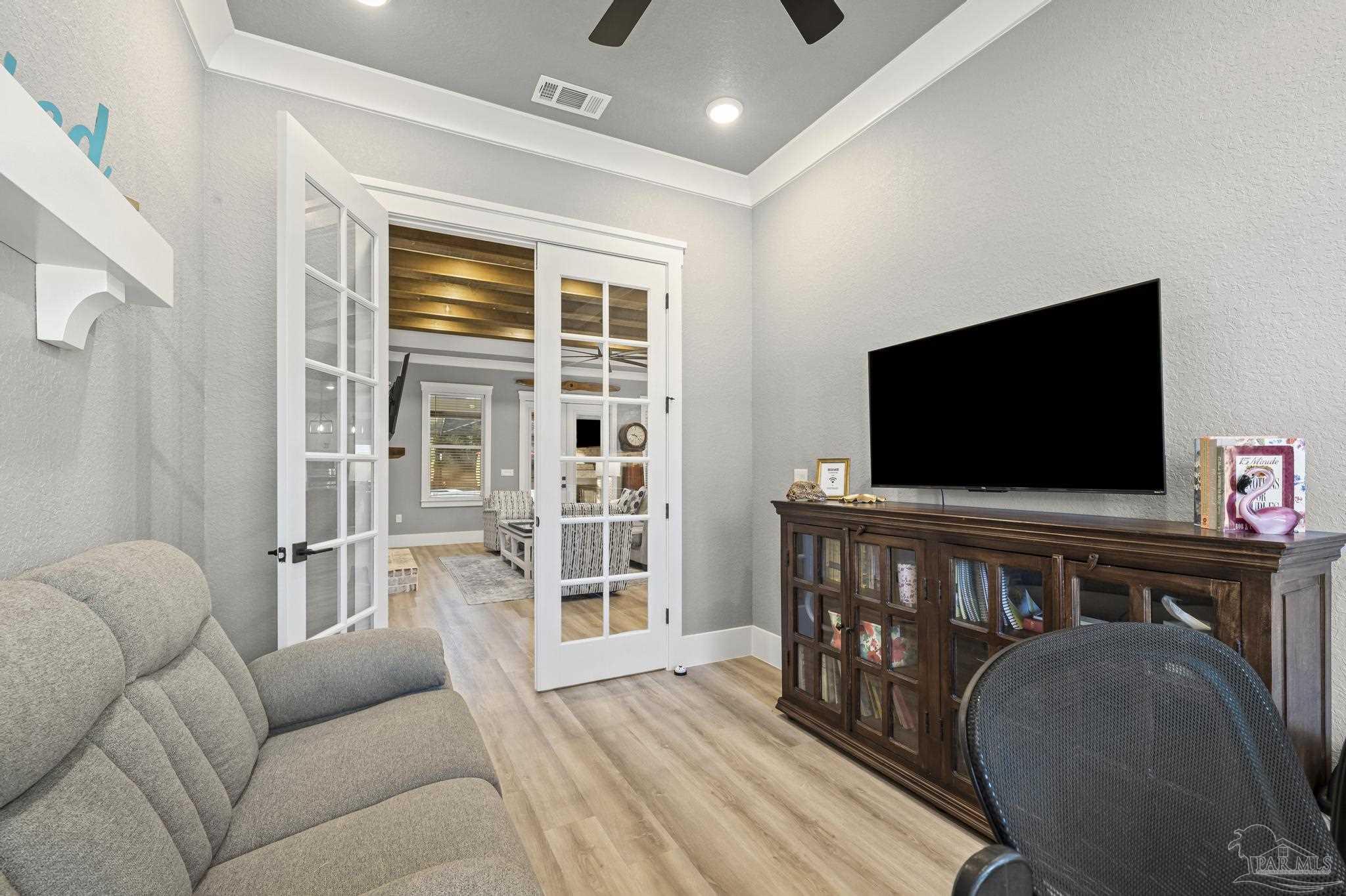 8415 Beulah Road Pensacola, FL 32526 - Photo 8 of 59 a living room with furniture and a flat screen tv