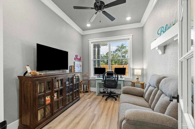 a living room with furniture a rug and kitchen view