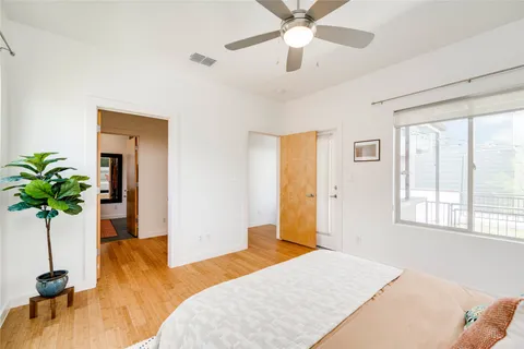 a bedroom with a bed and a potted plant