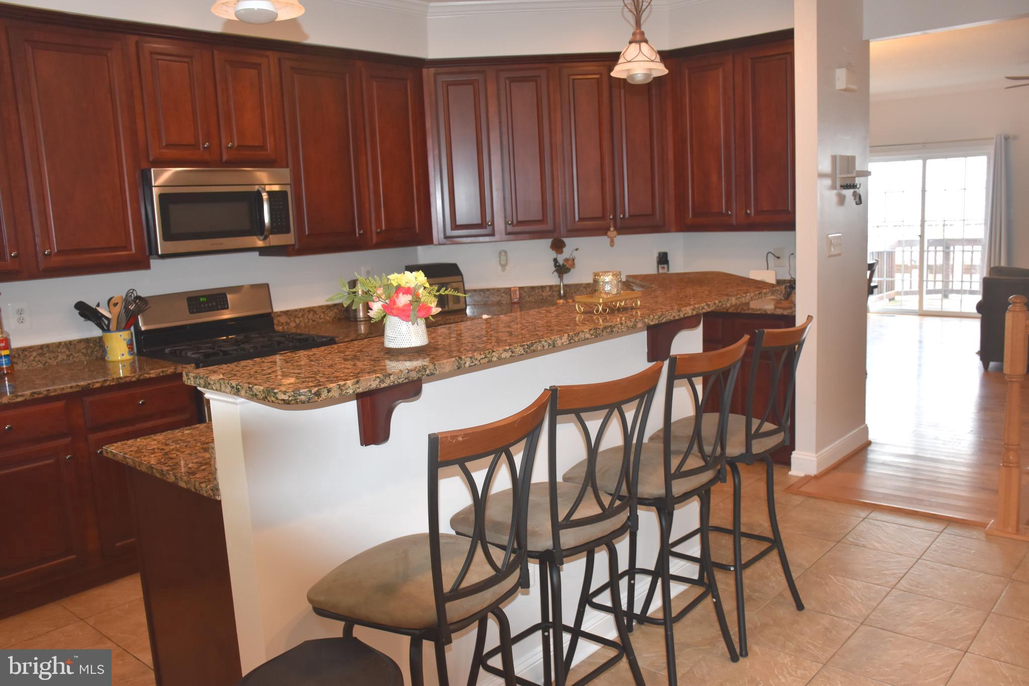 803 Ryan Street Baltimore, MD 21230 - Photo 15 of 41 a kitchen with a dining table chairs and a refrigerator