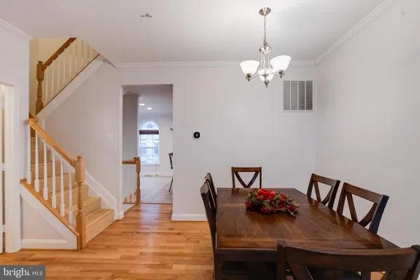 a view of a dining room with furniture wooden floor and chandelier