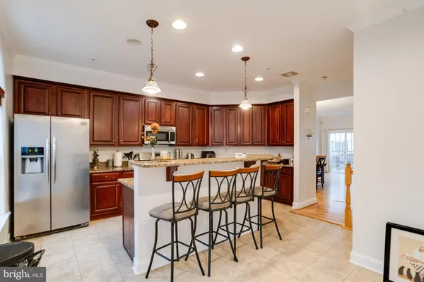 a bedroom with a large bed and wooden floor