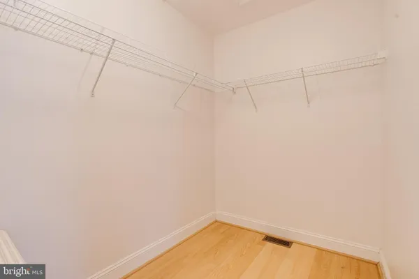 a view of a street with a car parked on the road