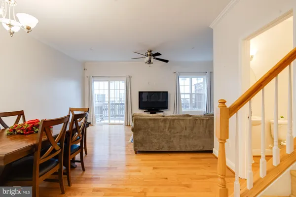a living room with furniture and a dining table