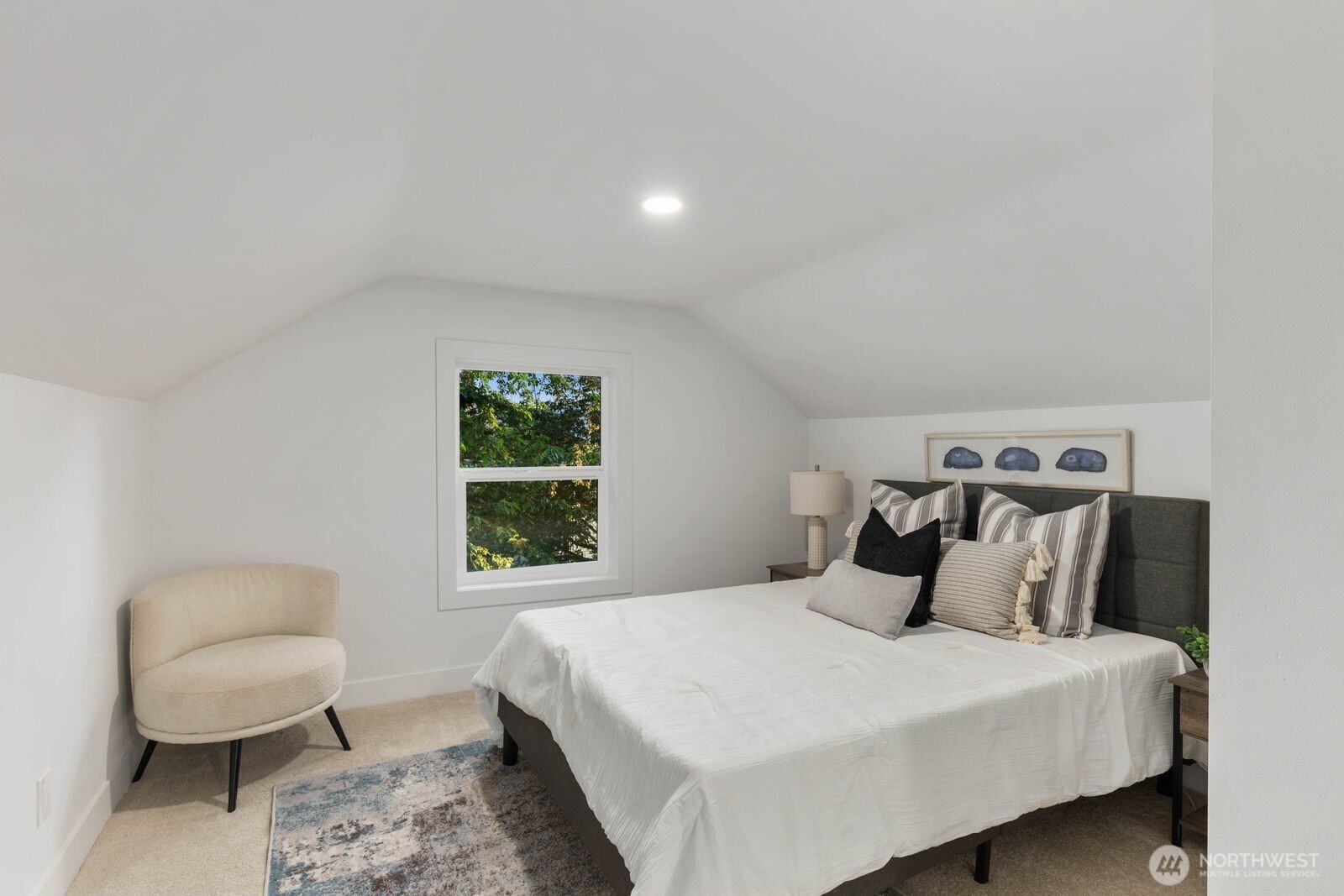 512 Northwest 44th Street Seattle, WA 98107 - Photo 17 of 37 a bedroom with a bed and a chair