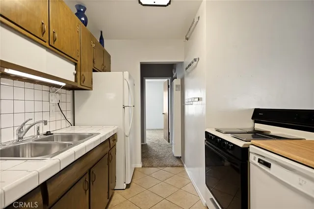 a kitchen that has a sink and a stove