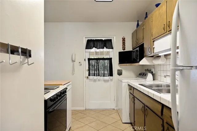 a kitchen with stainless steel appliances a stove and a refrigerator