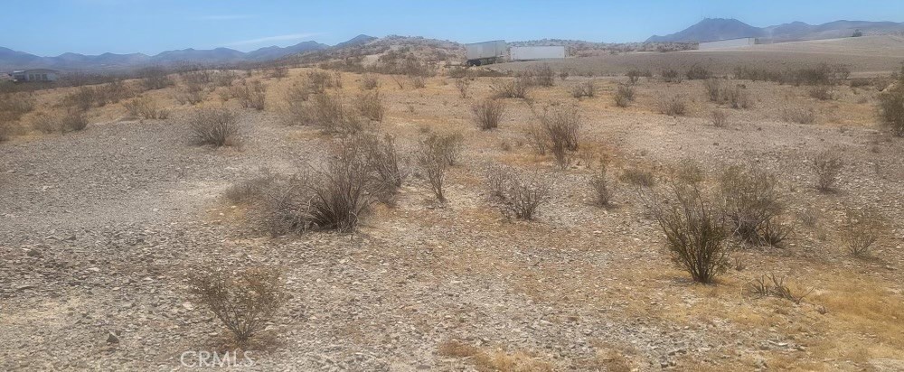 a view of mountain with trees in the background