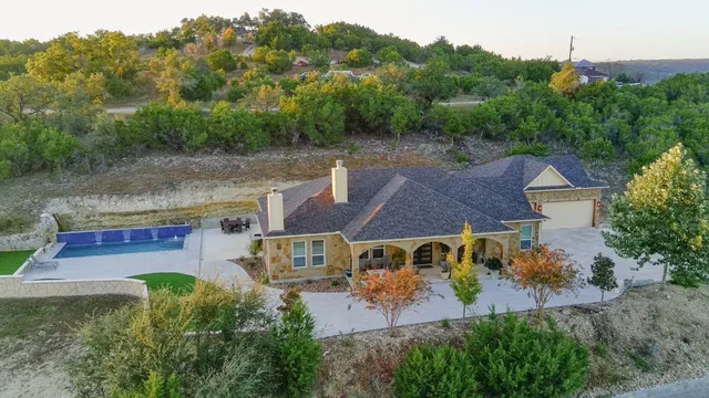 an aerial view of a house with a yard