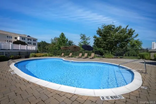 a view of a swimming pool with an outdoor seating and a yard