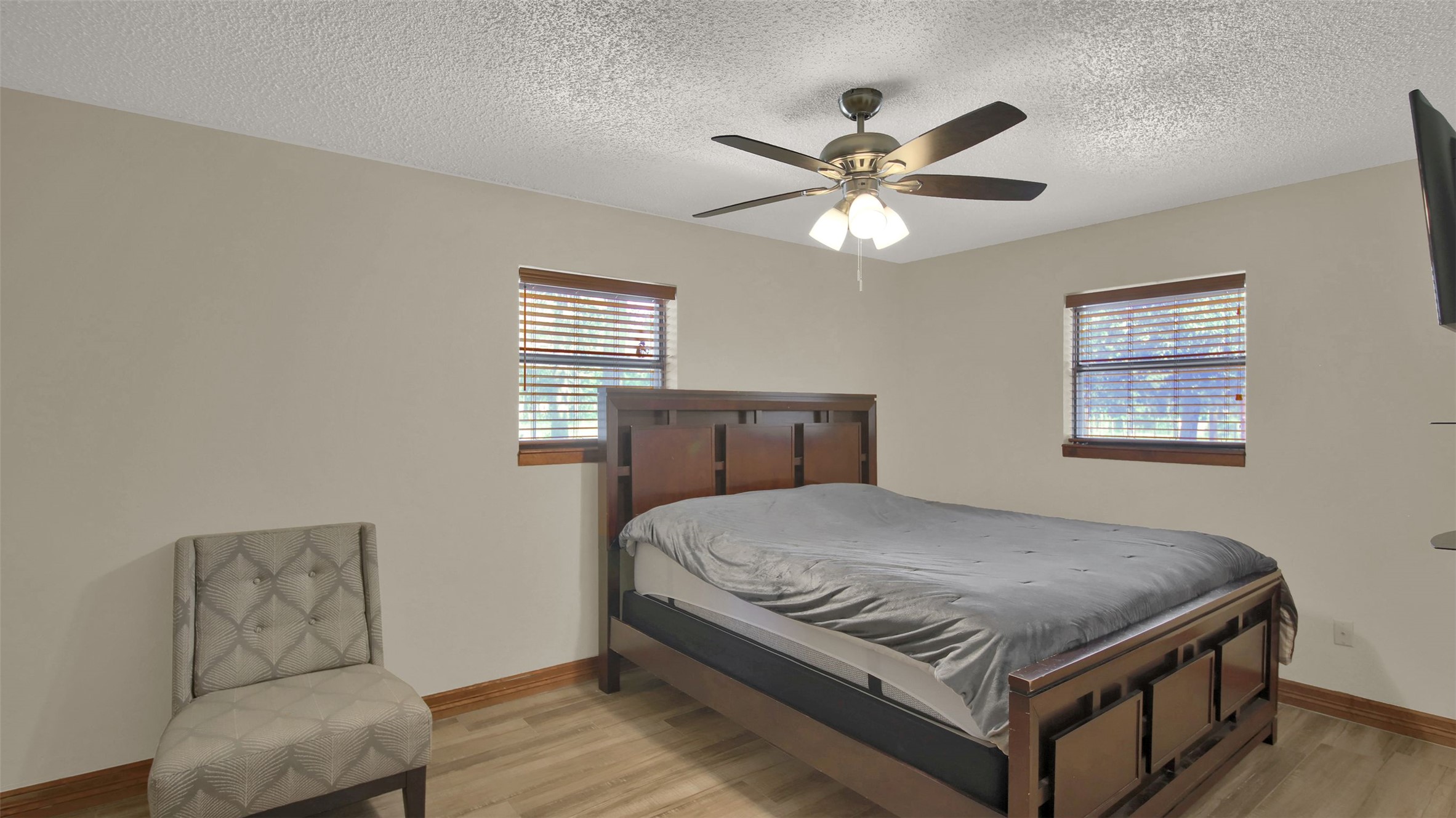 191 Jordan Lane Elgin, TX 78621 - Photo 11 of 29 Warm wood flooring and dual windows create a restful atmosphere in this cozy bedroom.