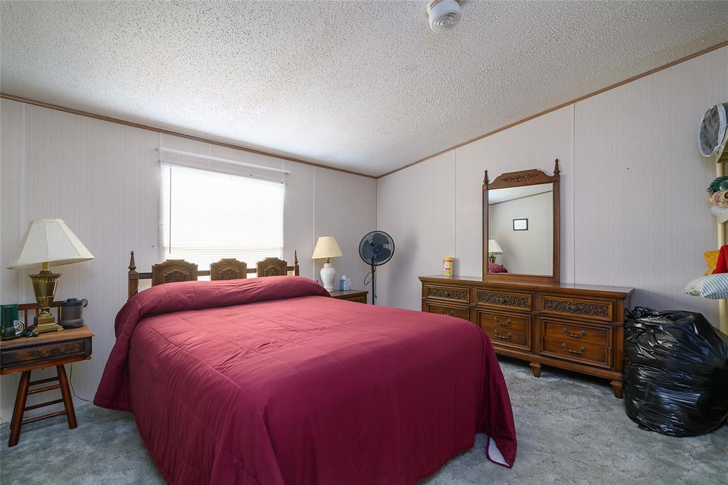 122 Grice Road Ringgold, LA 71068 - Photo 11 of 26 Bedroom featuring paneled walls and a window with blinds