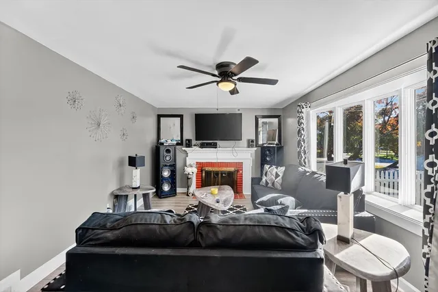 a living room with furniture a fireplace and a flat screen tv