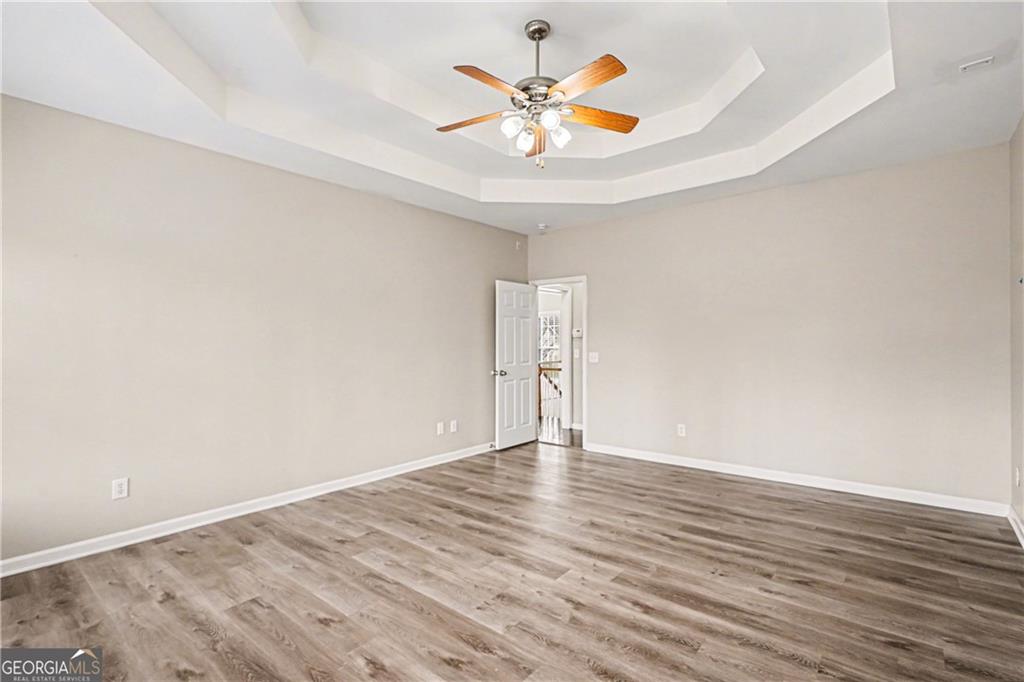 159 Sable Trace Trail Acworth, GA 30102 - Photo 16 of 40 an empty room with wooden floor and a ceiling fan
