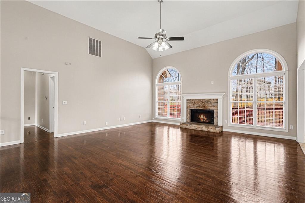 159 Sable Trace Trail Acworth, GA 30102 - Photo 5 of 40 an empty room with wooden floor fireplace and windows
