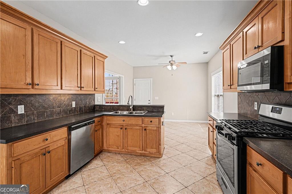 159 Sable Trace Trail Acworth, GA 30102 - Photo 10 of 40 a kitchen with stainless steel appliances granite countertop a stove a sink and a microwave