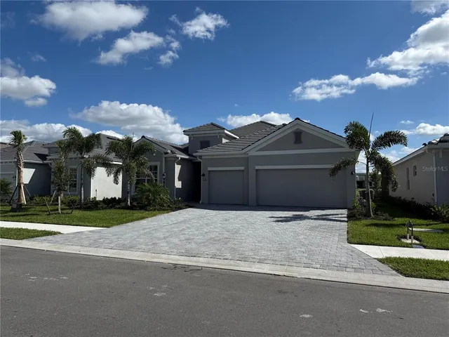 a front view of a house with a yard and garage