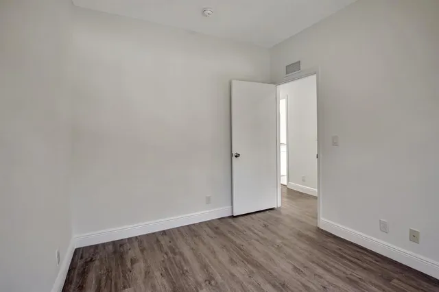 a view of an empty room and wooden floor