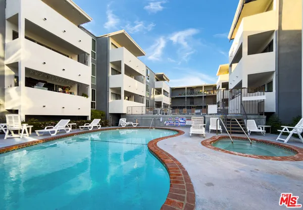 a swimming pool with outdoor seating and yard