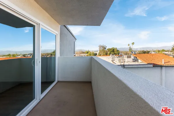 a view of a balcony from an empty room