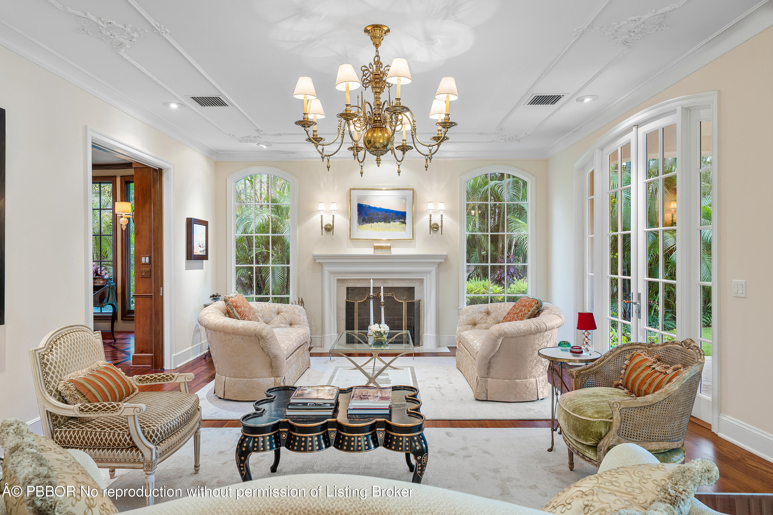 242 Wells Road Palm Beach, FL 33480 - Photo 9 of 54 a living room with furniture chandelier and a fireplace