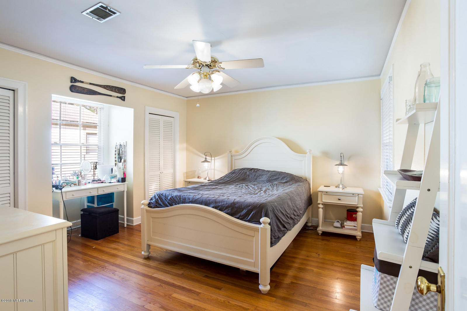 1435 Nicholson Road Jacksonville, FL 32207 - Photo 11 of 24 a bedroom with a bed and a chandelier