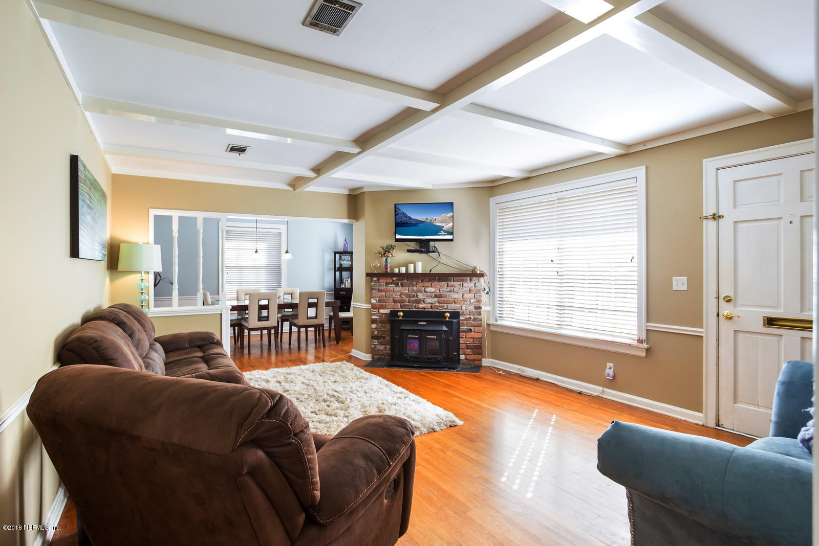 1435 Nicholson Road Jacksonville, FL 32207 - Photo 12 of 24 a living room with furniture a fireplace and a flat screen tv