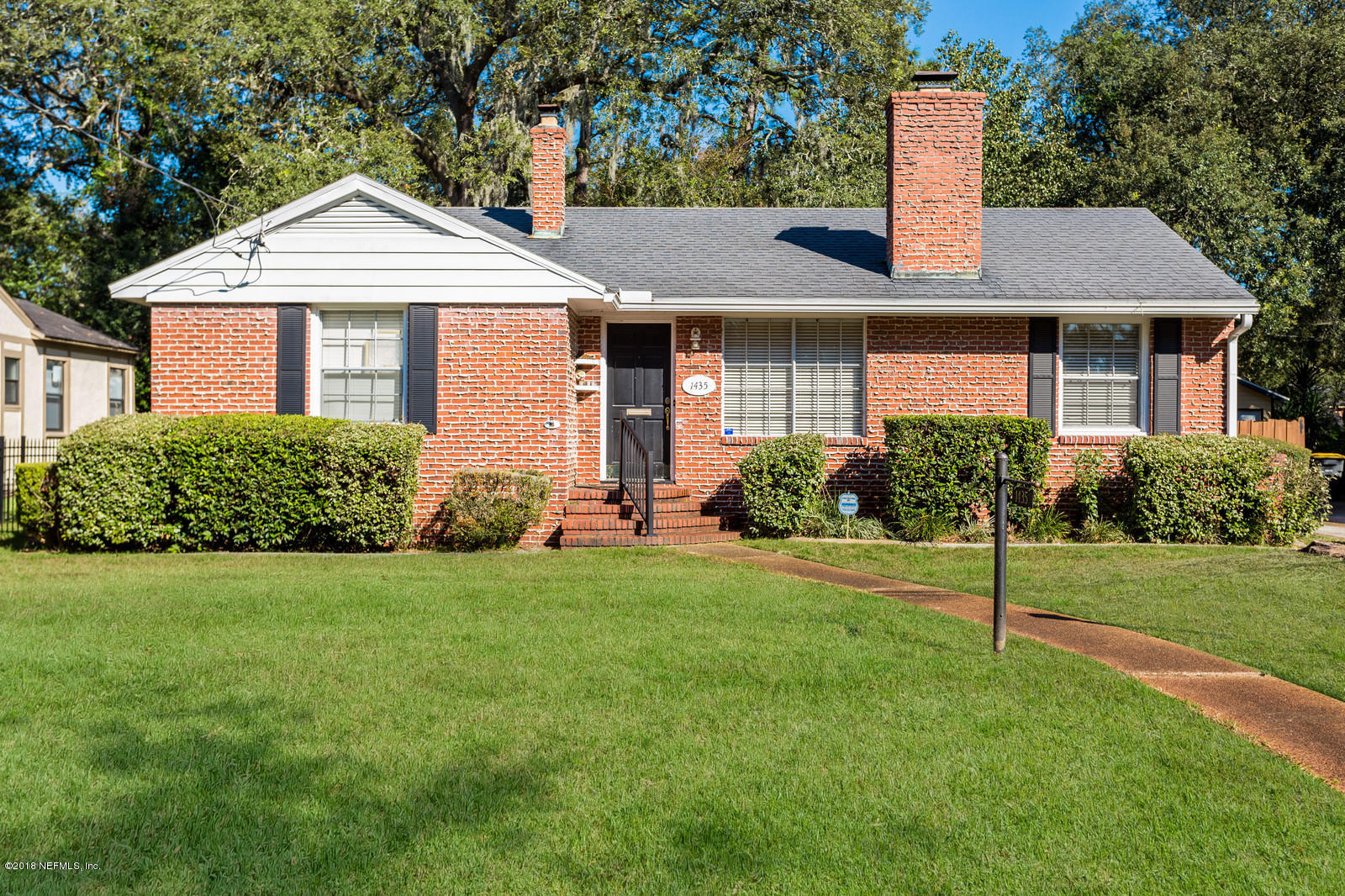 1435 Nicholson Road Jacksonville, FL 32207 - Photo 2 of 24 a front view of a house with a yard and garage
