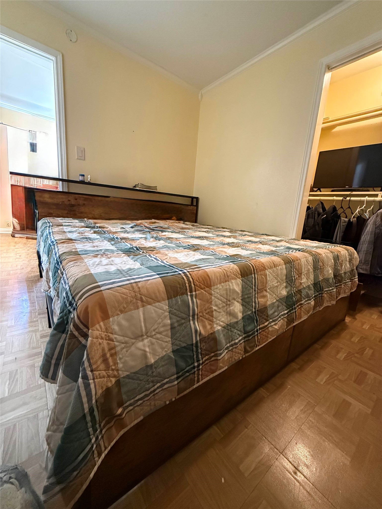 7047 Bissonnet Street, Unit 32 Houston, TX 77074 - Photo 14 of 19 a bed sitting in a bedroom next to a window