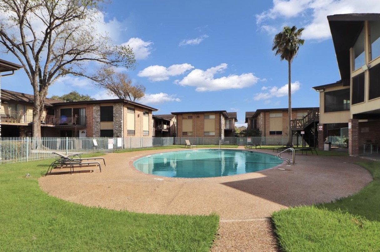 7047 Bissonnet Street, Unit 32 Houston, TX 77074 - Photo 19 of 19 a front view of a house with garden and patio