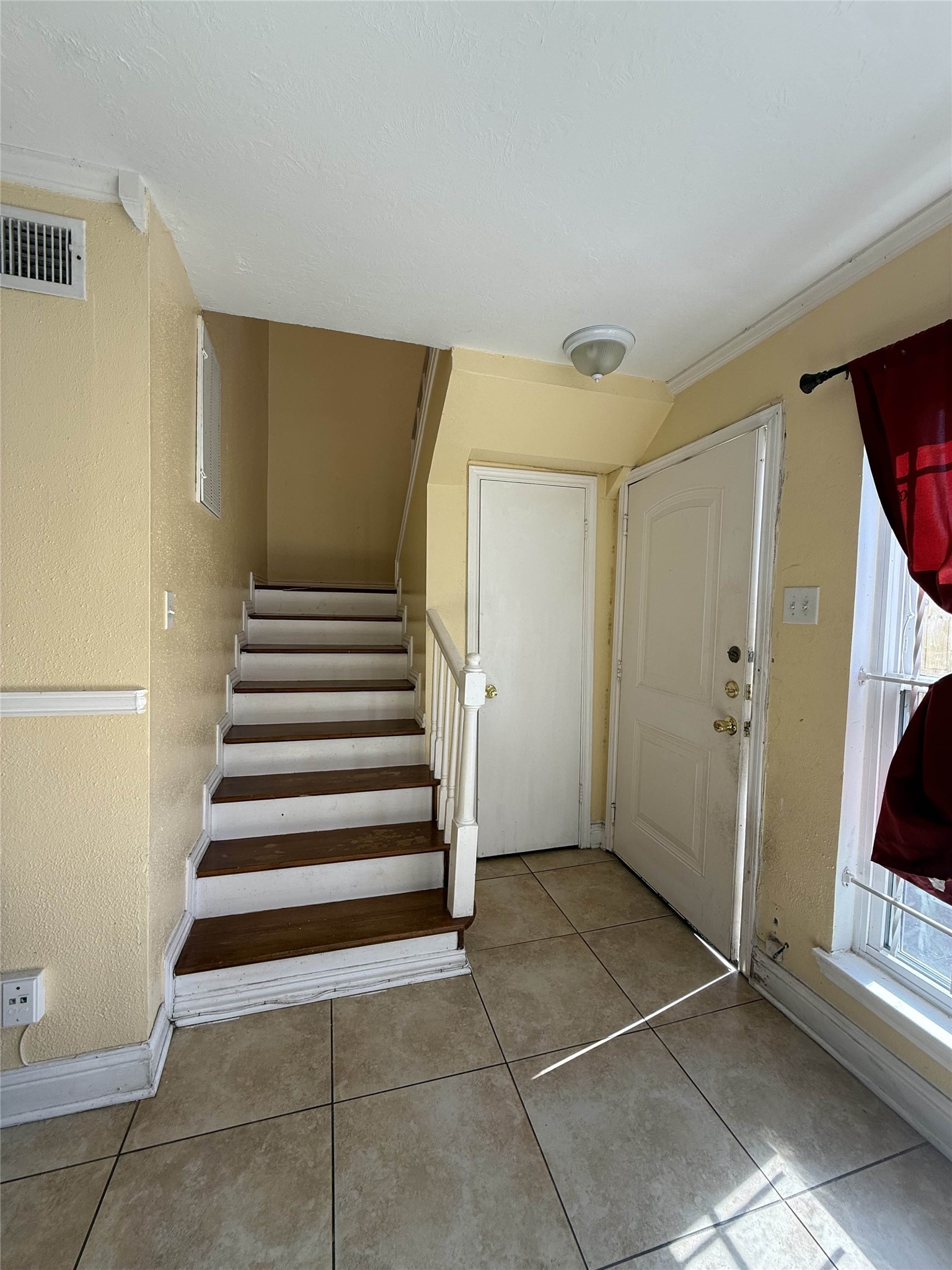7047 Bissonnet Street, Unit 32 Houston, TX 77074 - Photo 3 of 19 a view of an entryway with staircase