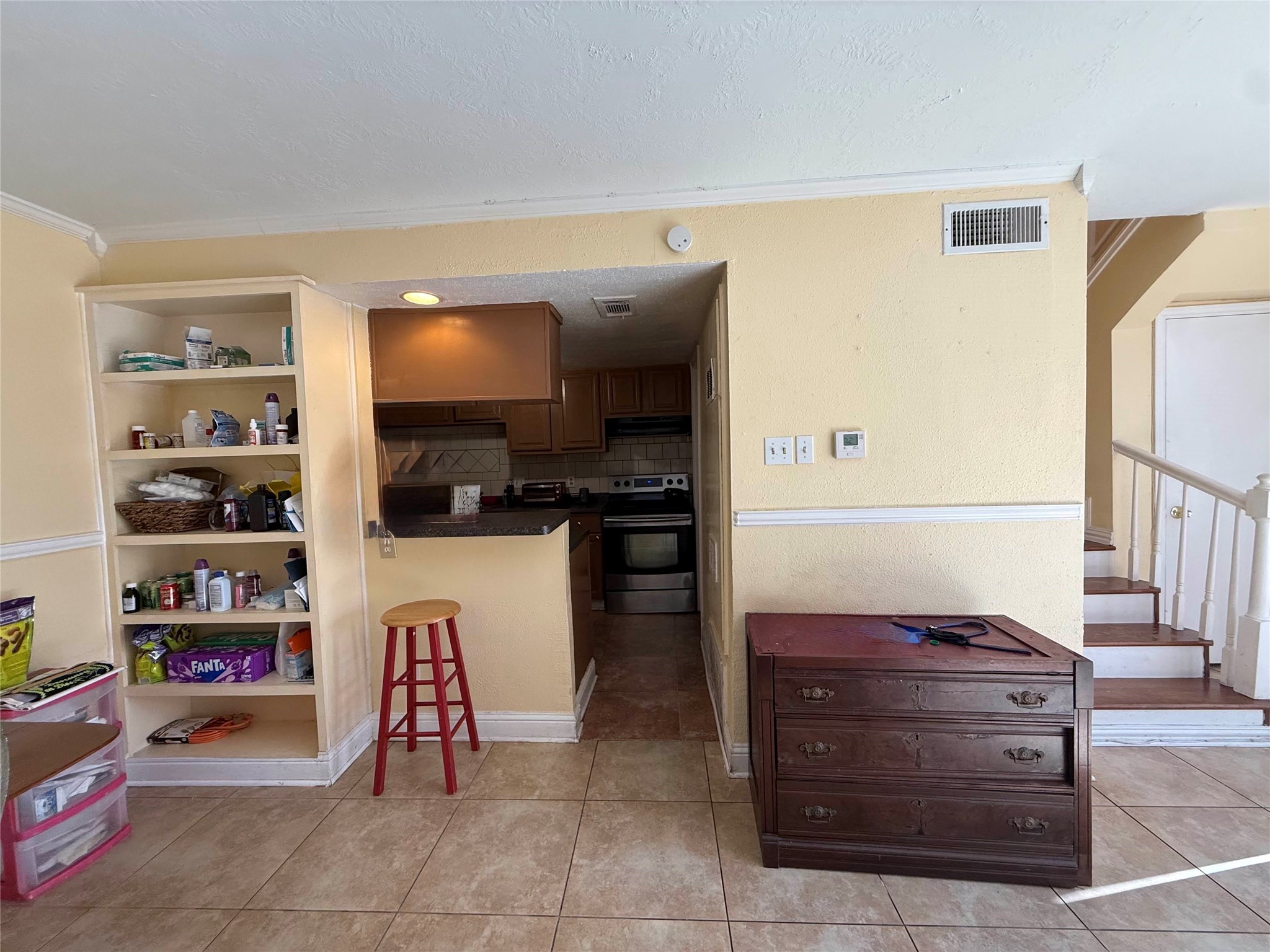 7047 Bissonnet Street, Unit 32 Houston, TX 77074 - Photo 5 of 19 a kitchen with a refrigerator and a stove top oven