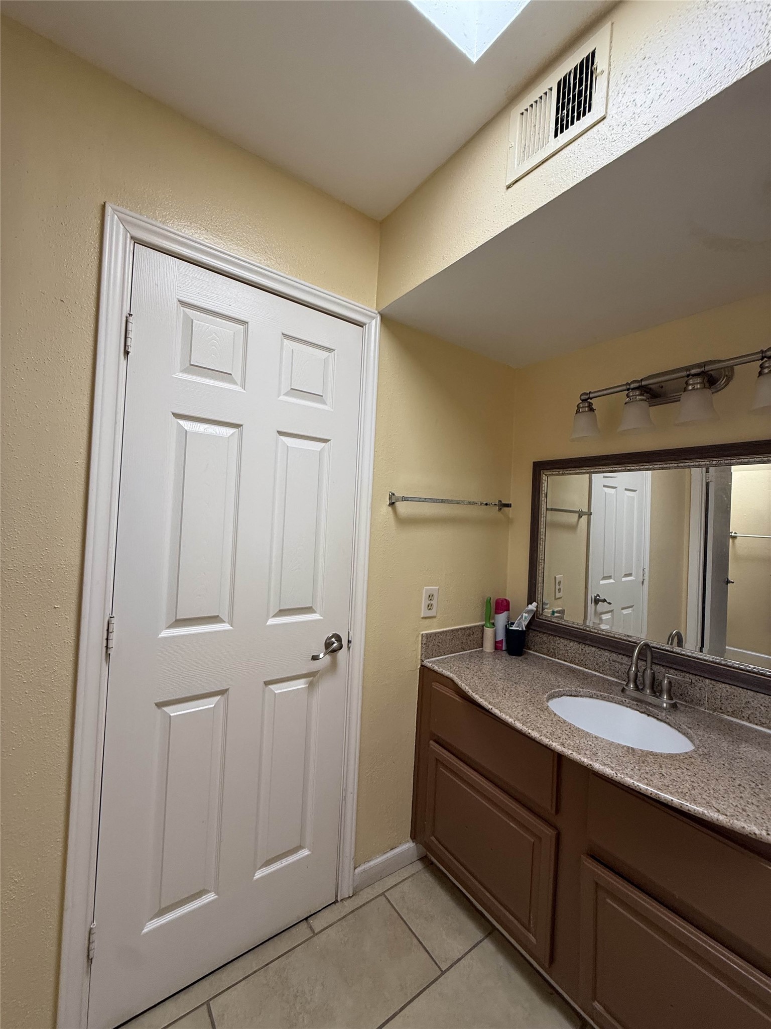 7047 Bissonnet Street, Unit 32 Houston, TX 77074 - Photo 9 of 19 a bathroom with a double vanity sink and a mirror