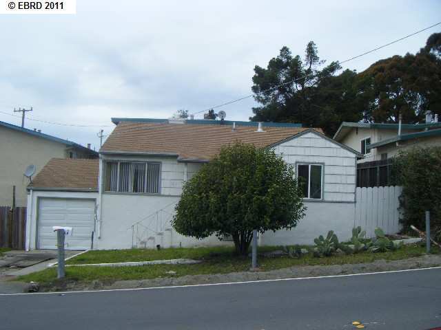 5417 Alpine Road San Pablo, CA 94806 - Photo 1 of 1 a front view of a house with a garden and trees