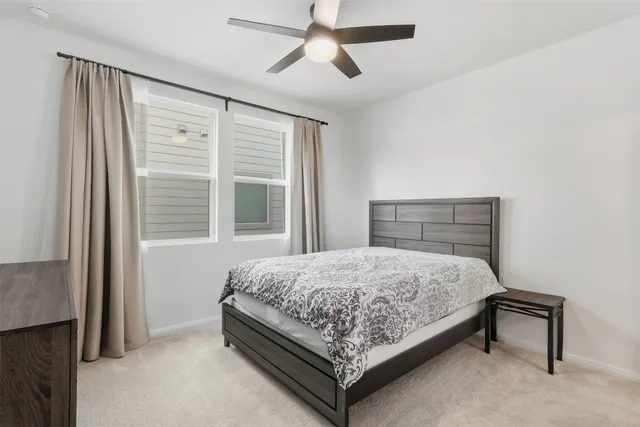 a bedroom with a bed lamp and a window