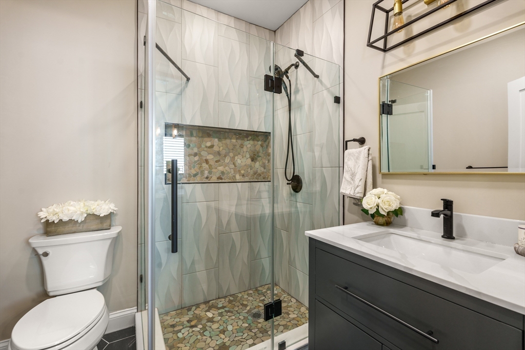 58 Dustin Street, Unit 1 Boston, MA 02135 - Photo 13 of 29 a bathroom with a sink a toilet and shower