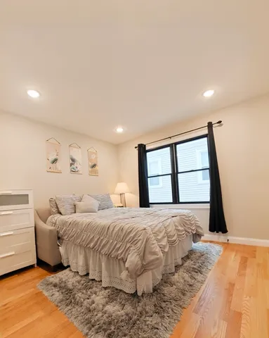 a bedroom with a large bed and a large window