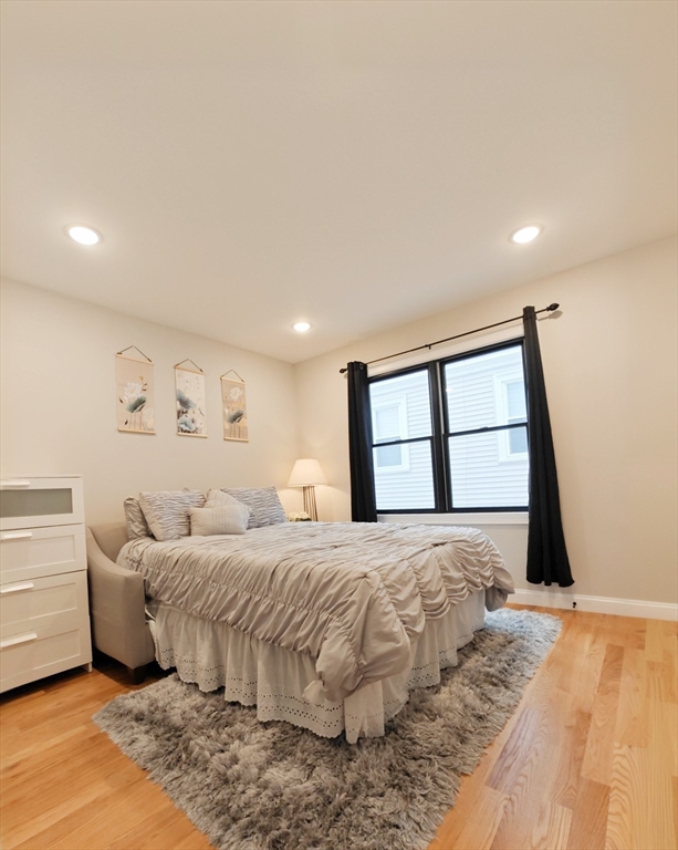 58 Dustin Street, Unit 1 Boston, MA 02135 - Photo 14 of 29 a bedroom with a large bed and a large window