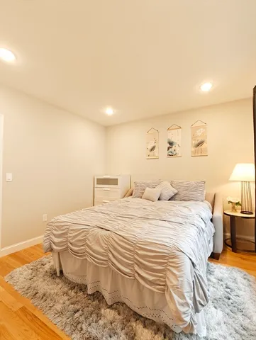 a bedroom with a bed and chair