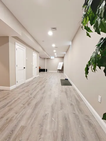 a view of a room with wooden floor
