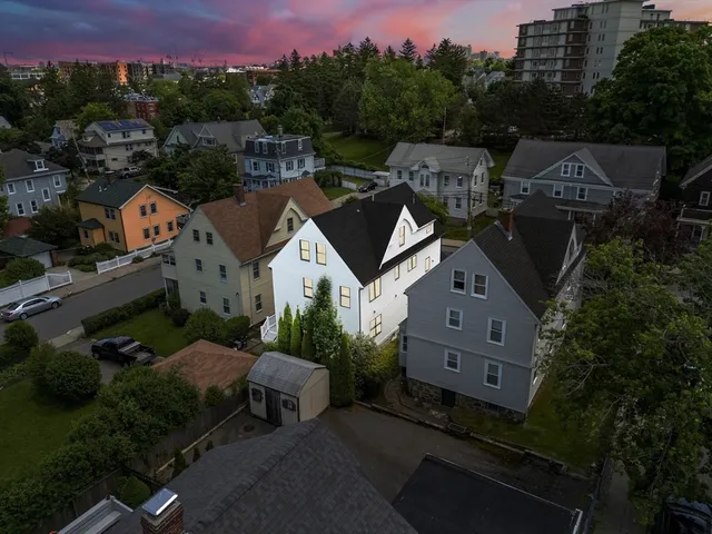 an aerial view of a house with a yard