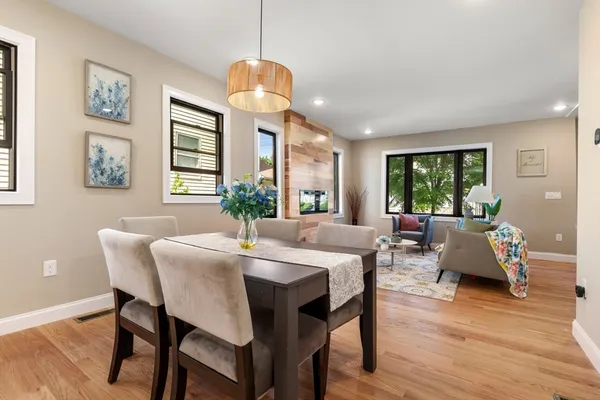 a view of a dining room with furniture window and wooden floor
