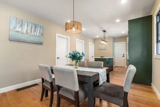 a view of a dining room with furniture wooden floor and a chandelier