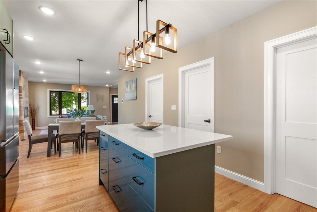 58 Dustin Street, Unit 1 Boston, MA 02135 - Photo 7 of 29 a kitchen with a table chairs and wooden floor