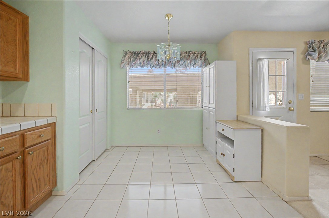 2243 Rugged Mesa Drive Laughlin, NV 89029 - Photo 31 of 32 A cheerful eat-in kitchen with tiled flooring and a convenient pantry.