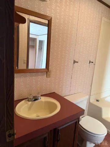 a bathroom with a toilet and shower