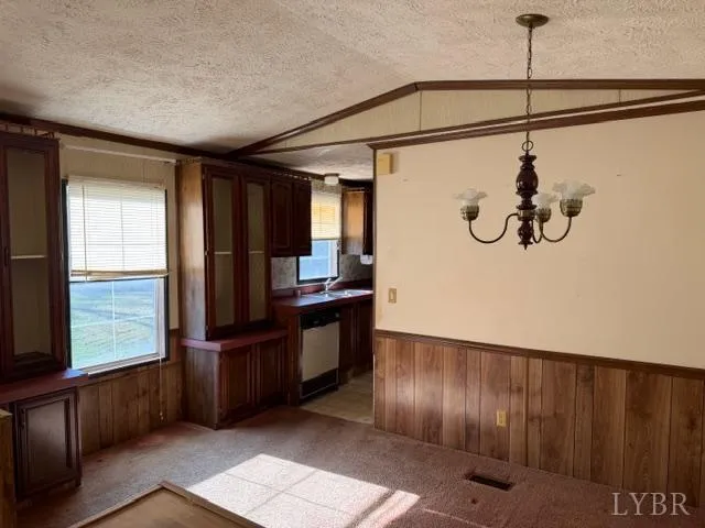a kitchen with wooden cabinets a sink and a stove