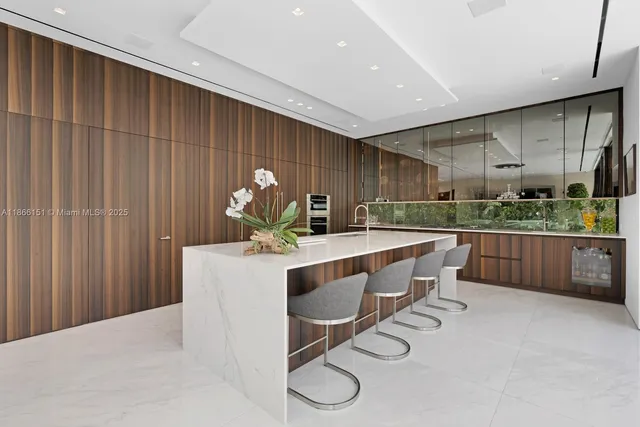 a living room with couches a coffee table and a large window with garden view